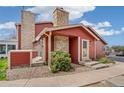 Charming red home with stone accents, landscaped front yard, and inviting entryway at 8424 Everett Way # A, Arvada, CO 80005