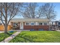 Inviting single-story home with a lush green lawn, mature trees, and a welcoming front porch at 3180 Mowry Pl, Westminster, CO 80031