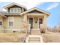 Inviting home featuring craftsman-style architecture with a shared front yard and walkway to front door at 4893 Newton St, Denver, CO 80221