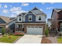 Beautiful two-story home with brick facade, two-car garage, and well-manicured lawn at 9807 Rosalee Peak St, Littleton, CO 80125