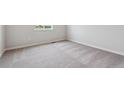 Bright, empty bedroom with neutral carpet, crisp white walls, and a sunlit window, ready for personal touches at 14412 Heritage Dr, Mead, CO 80504