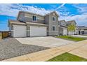 Charming gray home with three-car garage, manicured lawn, and neighboring houses, showcasing a Gathering-friendly community at 14412 Heritage Dr, Mead, CO 80504