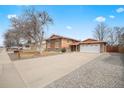 Charming two-story home with attached garage, long driveway, and landscaped front yard at 838 S 10Th Ave, Brighton, CO 80601