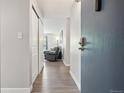 Inviting condo entryway with hardwood floors and a glimpse into the living space at 3465 S Poplar St # 305, Denver, CO 80224