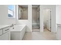Bright bathroom with a free-standing tub and walk-in shower enclosed with glass at 16537 Black Rose Cir, Parker, CO 80134