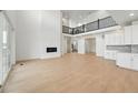 Bright living room with a fireplace, tall ceilings, and wood floors at 16537 Black Rose Cir, Parker, CO 80134