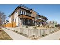 Modern house with a rooftop deck, clean lines, and manicured landscaping showcasing the property's exterior at 4201 Vallejo St, Denver, CO 80211