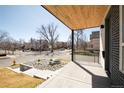Covered porch view showing the home's landscaped front yard and the surrounding neighborhood street view at 4201 Vallejo St, Denver, CO 80211
