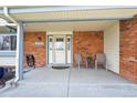 Cozy front porch features brick accents, neutral paint, and space for seating at 8201 Allison Ct, Arvada, CO 80005