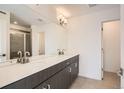 Bathroom featuring double sinks, sleek cabinetry, and a large mirror at 370 N. Geneva St, Aurora, CO 80010