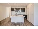 Modern kitchen with pendant lighting, island seating, and stainless steel appliances at 370 N. Geneva St, Aurora, CO 80010