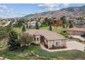 An inviting exterior of this single-story home features a well-manicured lawn and a charming stone-lined walkway at 11064 Hermitage Run, Littleton, CO 80125