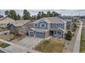 Stunning home exterior featuring a well-manicured lawn, and an attached two-car garage at 6746 S Biloxi Ct, Aurora, CO 80016