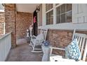 Charming front porch with white rocking chairs, stone accents, and stylish decor at 6746 S Biloxi Ct, Aurora, CO 80016