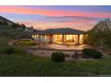 Picturesque backyard with a covered patio, seating, and lush landscaping at 4305 Easley Rd, Golden, CO 80403
