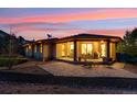 Inviting covered patio with comfortable seating and a barbecue area, perfect for outdoor living at 4305 Easley Rd, Golden, CO 80403