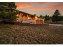A well-maintained home with a brick exterior, two-car garage, and professionally landscaped yard at 5808 Crestbrook Cir, Morrison, CO 80465