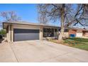 This brick home features an attached garage and cozy front porch at 241 S 15Th Ave, Brighton, CO 80601