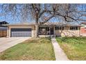 Charming brick home featuring a well-manicured lawn, attached garage, and cozy front porch at 241 S 15Th Ave, Brighton, CO 80601
