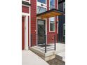 Close-up of the front entrance featuring a stylish awning and modern railing at 285 Clementina St, Louisville, CO 80027