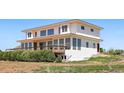 Back exterior showcasing a deck, a walkout basement, multiple windows, and stairs to the yard at 3160 Bella Rosa Pkwy, Longmont, CO 80504