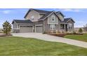 Attractive two-story home with three-car garage, stone accents and well-maintained landscaping at 8750 Red Primrose St, Franktown, CO 80116