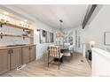 A dining area with sleek cabinets, modern lighting, and a bay window for ample natural light at 5814 Cole Way, Arvada, CO 80004