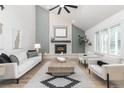 Bright living room featuring a fireplace, vaulted ceilings, and modern decor with comfortable furniture at 5814 Cole Way, Arvada, CO 80004
