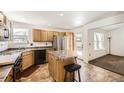 Functional kitchen with stainless steel appliances, a kitchen island, and plenty of counter space at 5770 Waverley Ave, Firestone, CO 80504