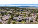 Expansive aerial view of a neighborhood featuring large homes with lush landscaping and mountain views at 4788 Silver Pine Dr, Castle Rock, CO 80108