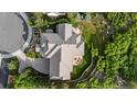 Aerial view of landscaped home showing stone patio with firepit and lush wooded surroundings at 4788 Silver Pine Dr, Castle Rock, CO 80108