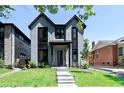 Charming gray two-story house with modern design, green lawn and landscaped surroundings at 3149 W 35Th Ave, Denver, CO 80211