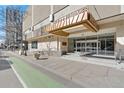 Exterior of the building entrance showing the street with a tree and an easy access walkway at 1777 Larimer St # 608, Denver, CO 80202