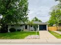 Charming single-Gathering home with lush front yard and a well-kept lawn at 8307 E Lehigh Dr, Denver, CO 80237
