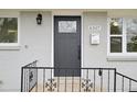 Close-up view of a modern front door and well-maintained exterior, showcasing curb appeal at 8307 E Lehigh Dr, Denver, CO 80237