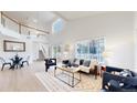 Bright living room with high ceilings, large windows, and modern furnishings at 11738 Zenobia Loop, Westminster, CO 80031