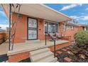 Inviting front porch with decorative railings and space for seating, perfect for enjoying the outdoors at 3670 Ivanhoe St, Denver, CO 80207