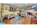 Bright living room featuring vibrant decor, hardwood floors, and a seamless transition to the adjacent kitchen at 8441 Mcdougal St, Denver, CO 80229
