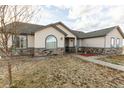 Beautiful home featuring stone accents, neutral siding, and well-kept landscaping at 16301 Hudson Rd, Hudson, CO 80642