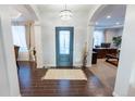 Inviting foyer with stylish tile flooring, high ceilings, and an elegant chandelier at 16301 Hudson Rd, Hudson, CO 80642