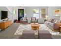 Bright living room with neutral paint, stylish furnishings, and a plush rug creating a cozy atmosphere at 12550 Eastlake Dr, Thornton, CO 80241