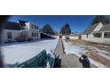Snowy backyard with walkway between houses at 230 S 22Nd Ave, Brighton, CO 80601