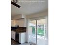 Bright kitchen with white cabinets, stainless steel appliances, and sliding door access to the outdoors at 230 S 22Nd Ave, Brighton, CO 80601
