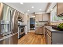 Kitchen area with stainless steel appliances, including fridge, oven and dishwasher at 8268 W Caley Pl, Littleton, CO 80123