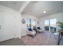 Bright living room featuring two accent chairs, large windows, and an open layout for easy entertaining at 46533 Avery Ln, Bennett, CO 80022