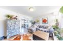 Open living room with hardwood floors, cozy seating, and modern decor at 1741 W 55Th Pl, Denver, CO 80221