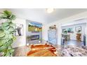Cozy living room with a modern fireplace, stylish decor, and hardwood floors at 1741 W 55Th Pl, Denver, CO 80221