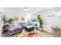 Bright living room featuring hardwood floors, a large window, and contemporary furnishings at 1741 W 55Th Pl, Denver, CO 80221