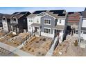 Aerial view of a modern townhouse with gray siding and solar panels on the roof at 8211 Monte Vista Cir, Littleton, CO 80125