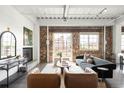 Inviting living room featuring a fireplace, exposed brick wall and comfortable seating area at 1435 Wazee St # 305, Denver, CO 80202